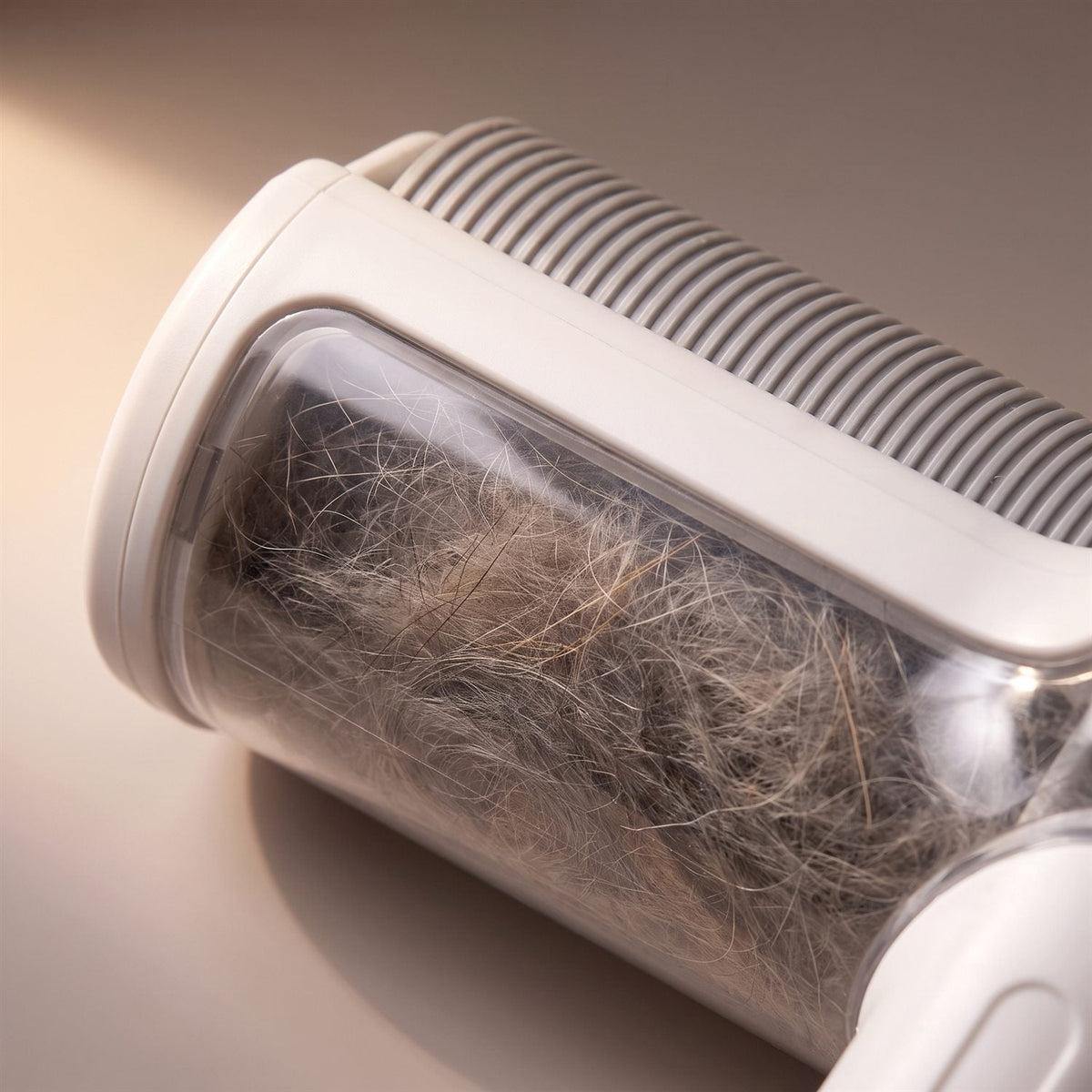 The roller's clear chamber full of collected hair
